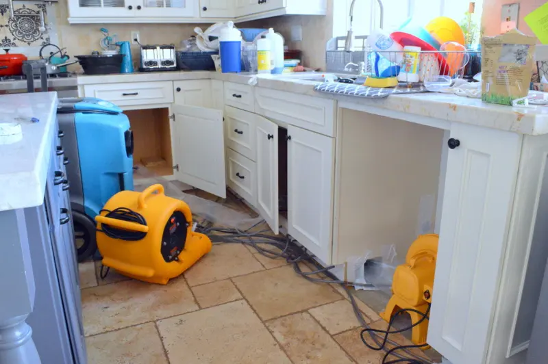 Air movers drying a Laguna Hills, CA kitchen after an appliance supply line leak