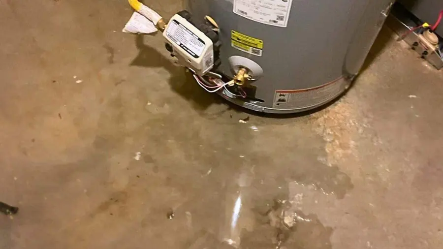 A failed water heater with water pooling at its base in a Laguna Hills, CA garage